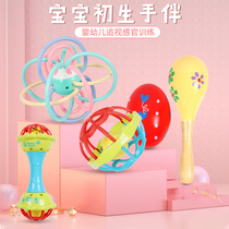 Newborn baby picking holes toys ringing bells grasping bells biting hands holding newborn baby sand hammer sand egg soft rubber ball