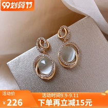 Lao Fengxiang cloud Cats Eye earrings female Xiaopu sterling silver senior sense round face temperament earrings 2021 New Tide