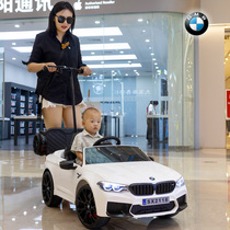 The new BMW childrens electric car four-wheel car remote control toy car can sit on the child with the swing baby stroller